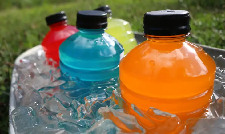 A photo of several electrolyte drink bottles in different colors.
