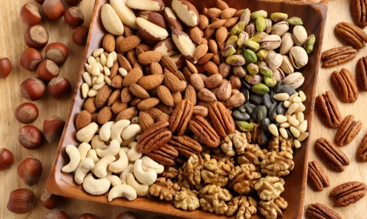 Assorted nuts on a wooden surface