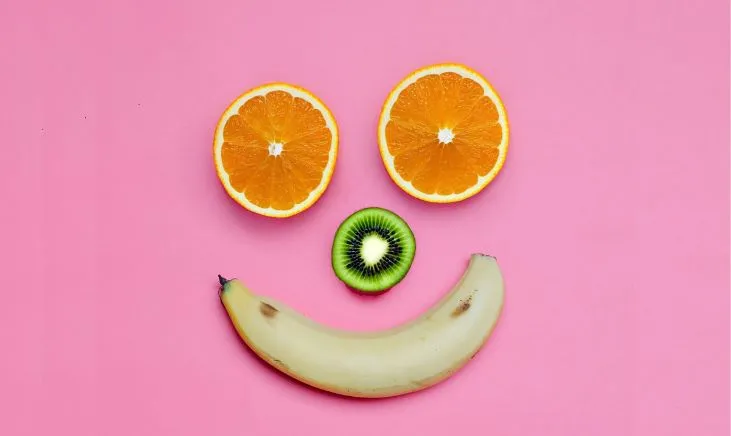 A selection of electrolyte-rich fruits arranged in a smiley face