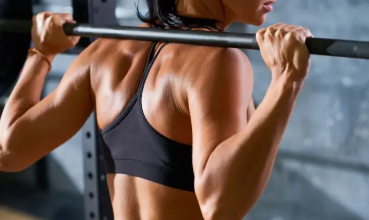 A picture of a woman lifting a barbell