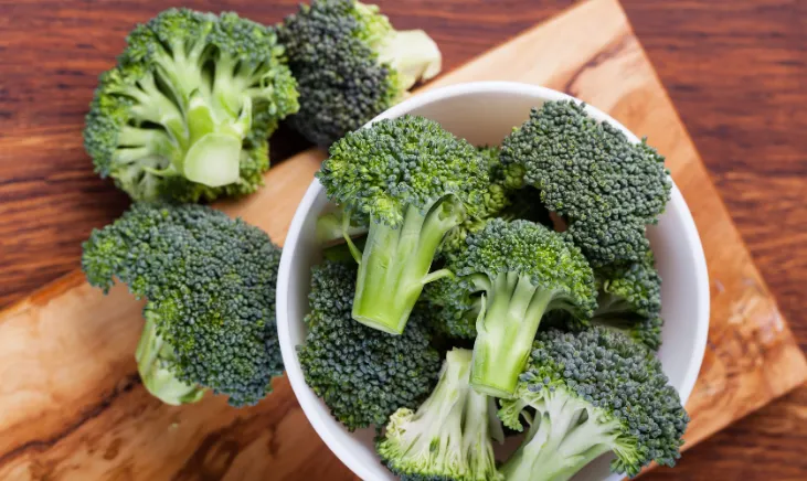 Fresh green broccoli florets in a bowl