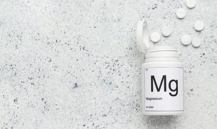Bottle of magnesium supplements on white background