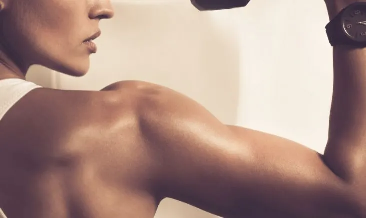 Strong woman showcasing powerful bicep muscles