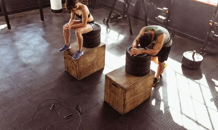 Two people are taking a break while working out.