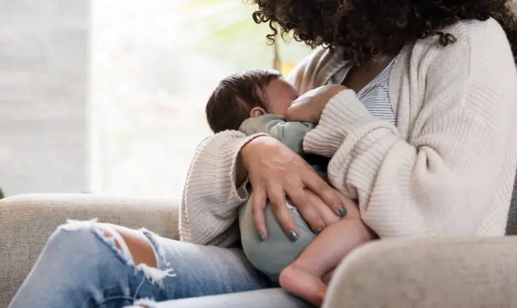 a women breastfeeding an infant 