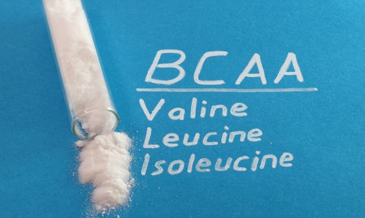 Close-up photo of a white, powdery substance filling a clear plastic tube, labeled "BCAA powder," showcasing a popular dietary supplement for muscle recovery and growth.