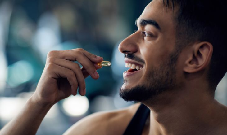 Close-up shot of a man happily taking a nutritional supplement, embracing a healthy lifestyle.