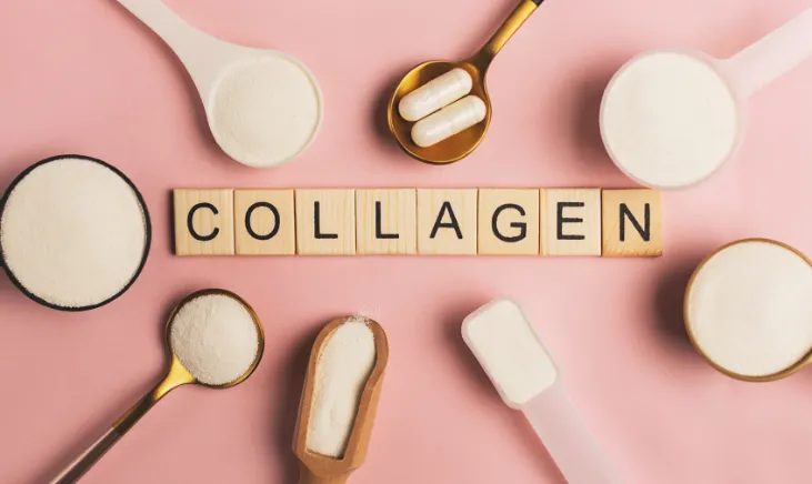 Text 'Collagen' on wood next to scattered white powder scoops