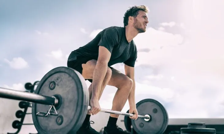 Determined man showcasing strength with weightlifting