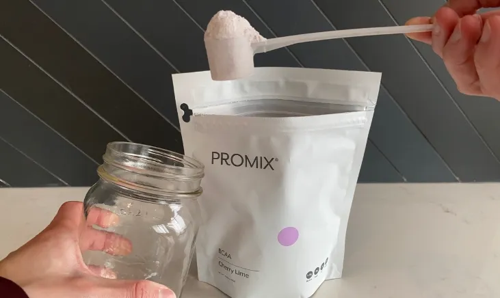 Promix BCAA Sachet powder being added to jar