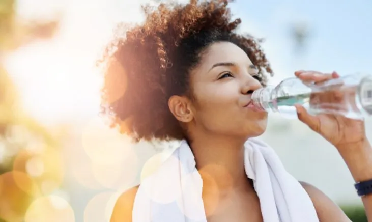 Active lady staying refreshed with water